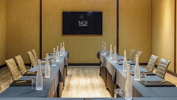 A conference room with a long table, chairs, and water bottles.
