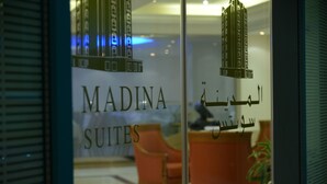 A glass door with the text "MADINA SUITES" and Arabic script. - Al Madina Suites Doha (Doha)