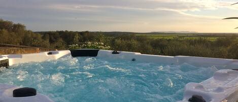 A hot tub with a view of a landscape.