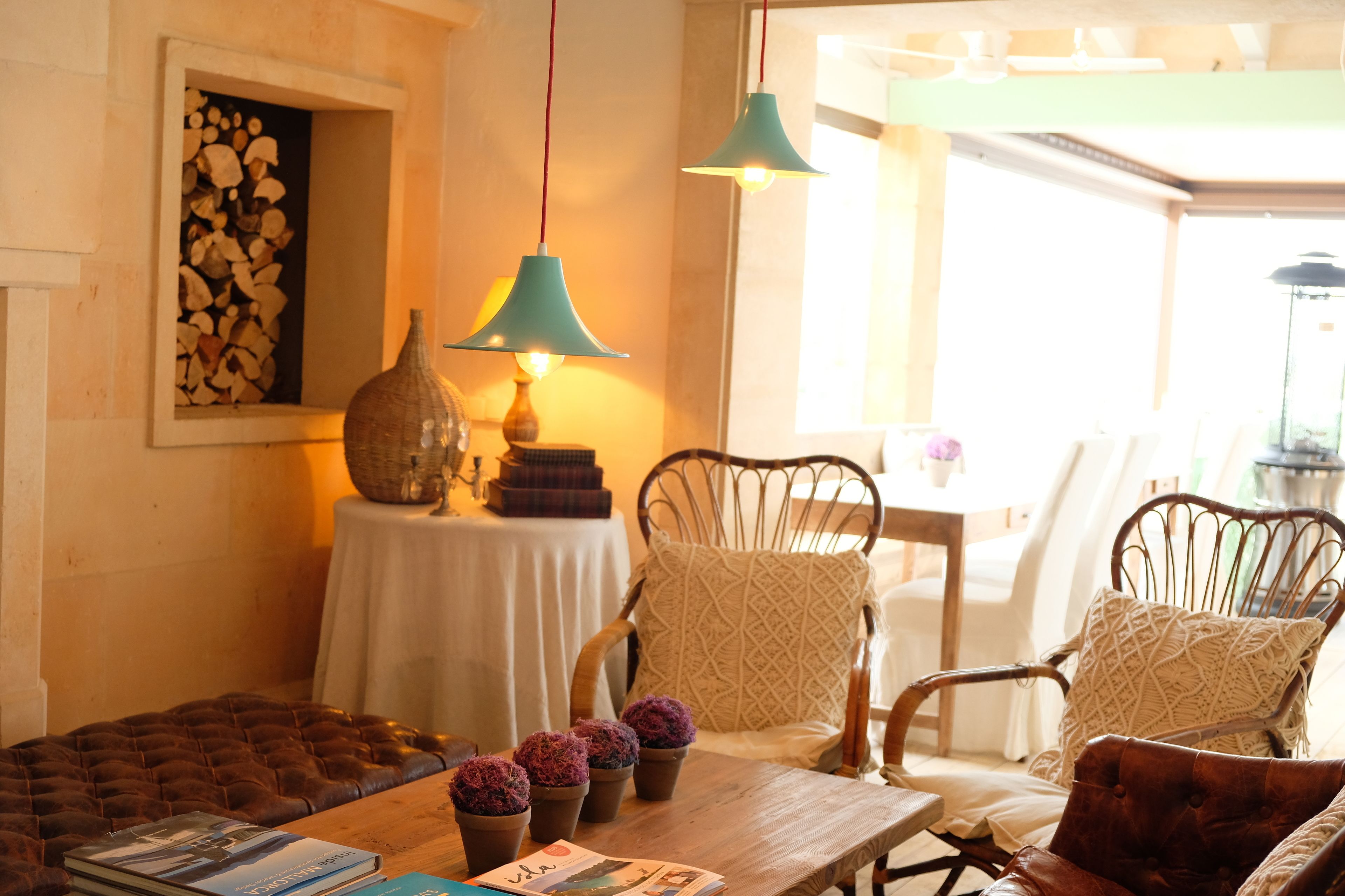 A cozy room with a wooden table, two chairs, a lamp, and a window with a view.