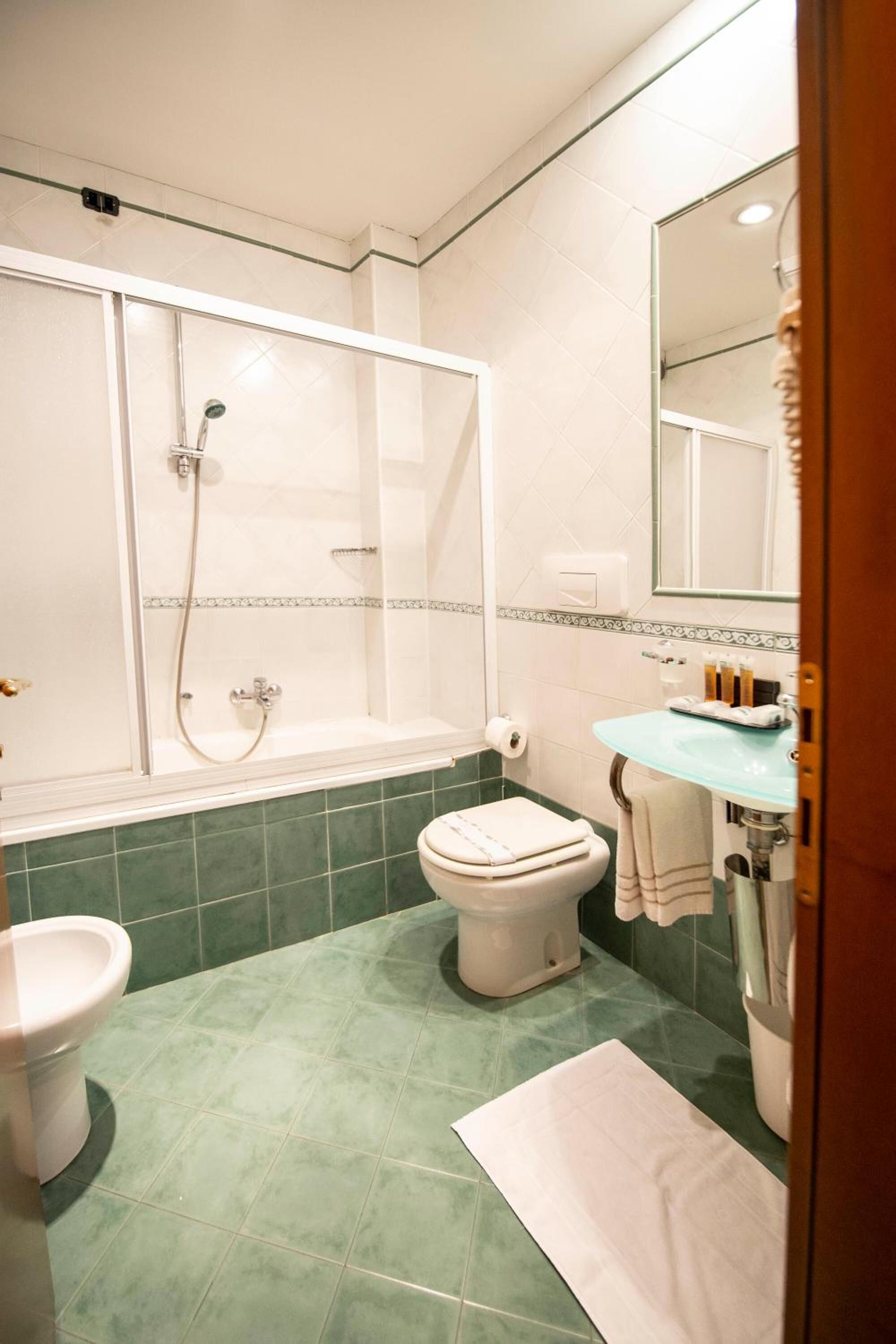 A bathroom with a bathtub, toilet, and sink.