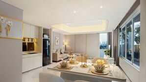 A modern kitchen with a dining area, large windows, and a city view. - Atria Hotel Gading Serpong (Gading Serpong)