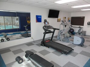 A gym with a treadmill, elliptical, and weights. - Best Western Plus Frisco East - McKinney (Frisco)
