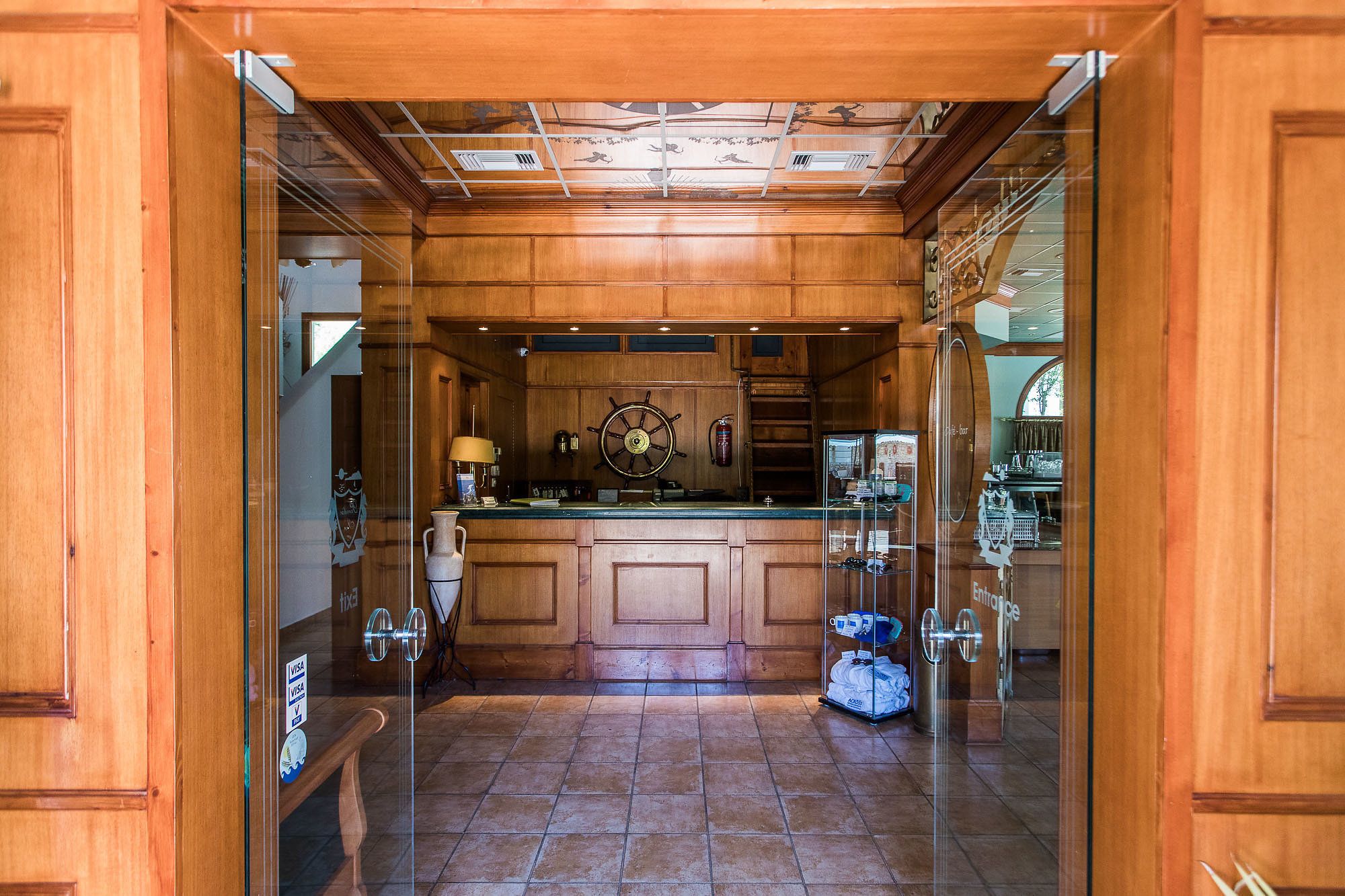 A spacious kitchen with wooden cabinetry, a central island, and a large window.