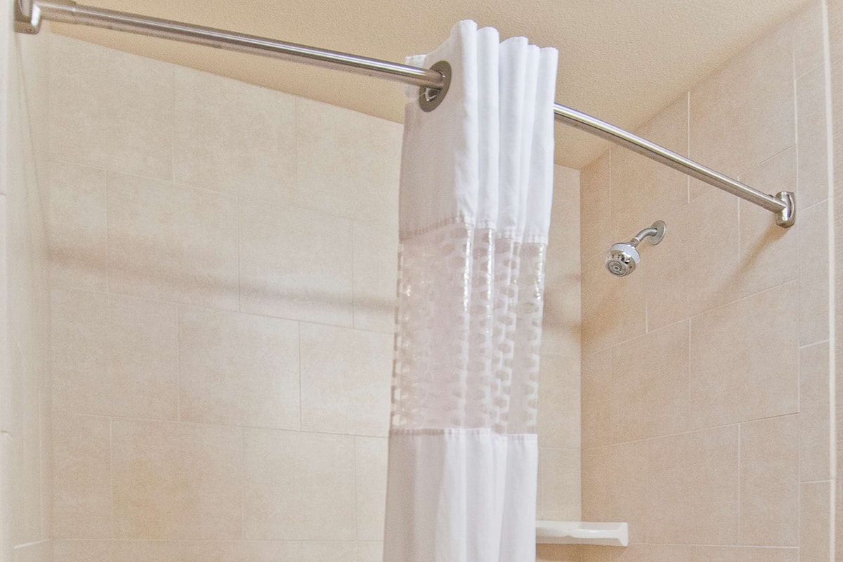 king bed with tub | bathroom | bathtub, hair dryer, bathrobes, towels