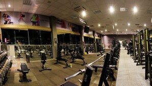 A gym with various exercise equipment, including dumbbells, benches, and weight machines. - Bernal Hotel (Ituiutaba)