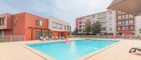 Seasonal outdoor pool, open 10:00 AM to 9:00 PM, pool umbrellas