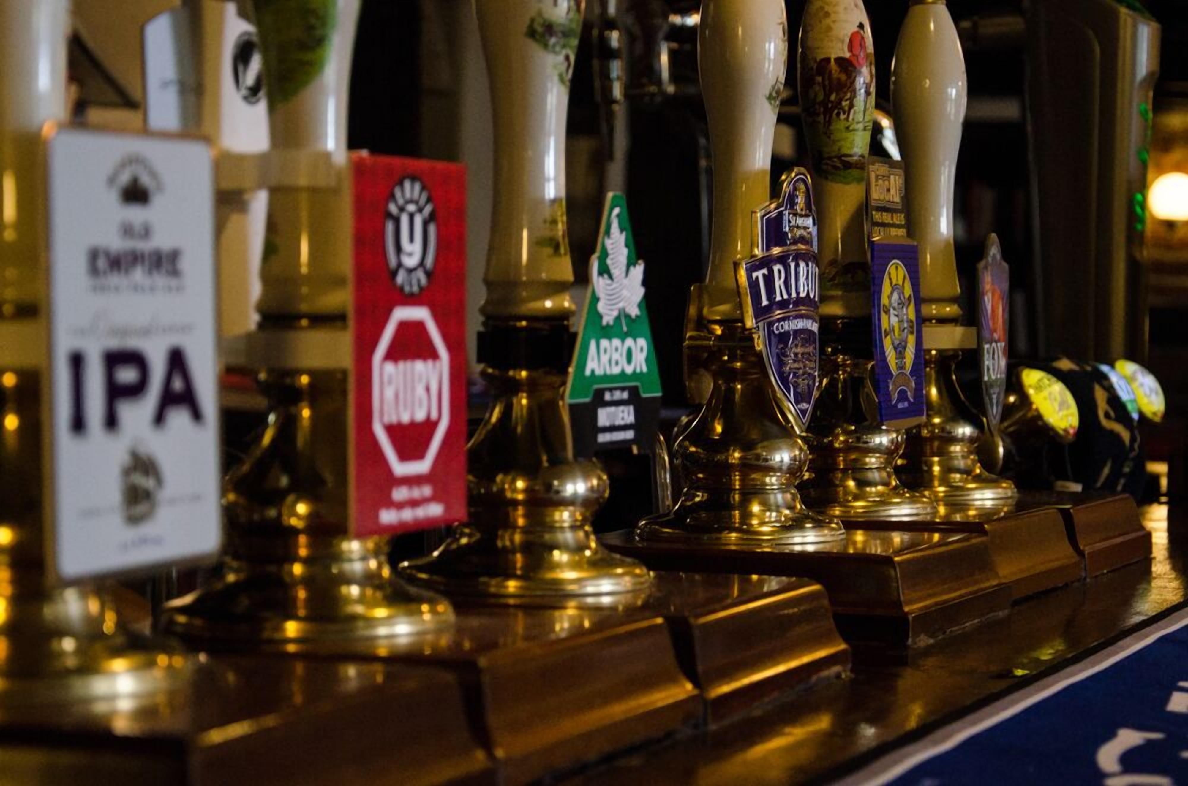 A bar with various beer taps labeled with different brands.