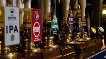 A bar with various beer taps labeled with different brands.