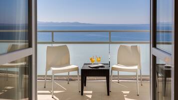 Enjoy breathtaking sea views from this balcony with a table for two and refreshing drinks at the ready.