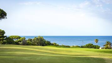 Enjoy a round of golf amidst lush green hills and scenic views of the ocean.