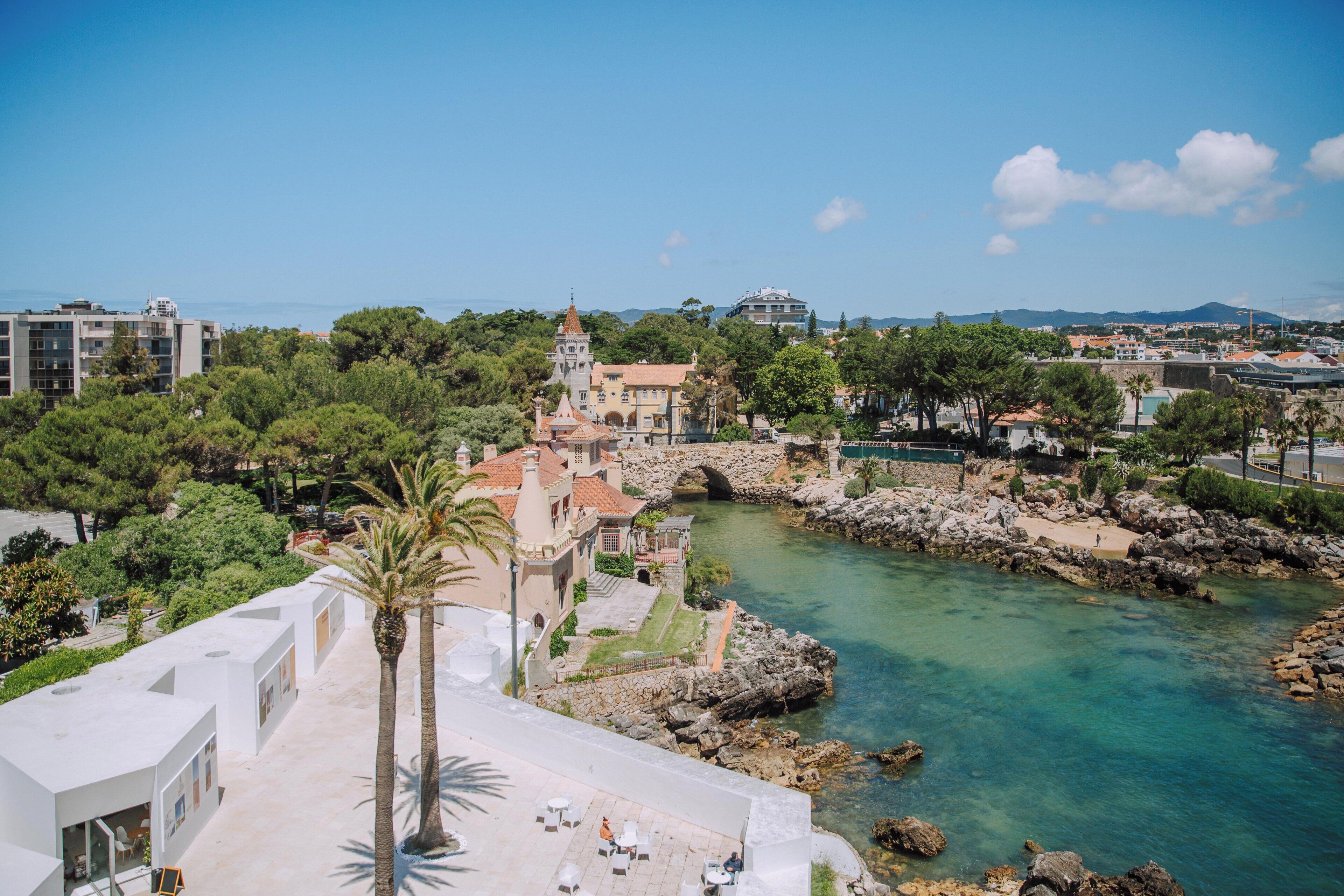 A coastal town with a prominent church, a river, and a bridge.