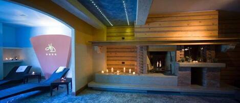 A spa area with massage chairs, a fireplace, and a ceiling with lights.