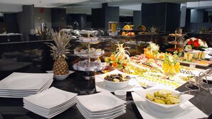 A buffet with various food items and a pineapple centerpiece. - Met Boutique Hotel - Boutique Class (Izmir)