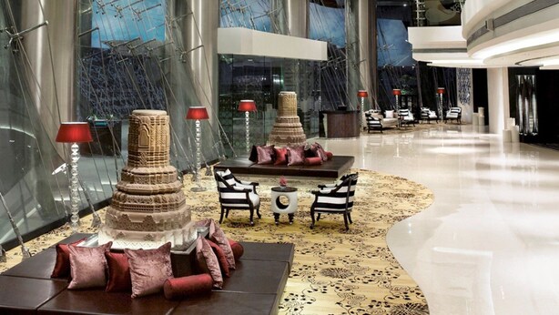 A spacious lobby with a grand chandelier, a decorative tower, and modern seating areas. - Sofitel Mumbai BKC Hotel (Mumbai)
