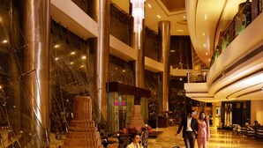 A spacious lobby with high ceilings, large chandeliers, and a central seating area with a patterned carpet. - Sofitel Mumbai BKC Hotel (Mumbai)