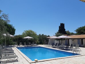 Outdoor pool, open 9:00 AM to 9:00 PM, pool loungers