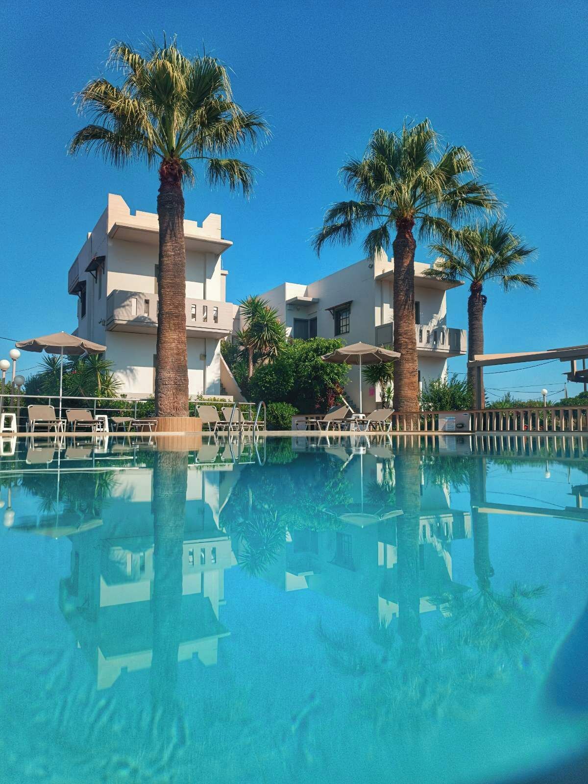 Outdoor pool, open 8:00 AM to 7:00 PM, pool umbrellas, pool loungers