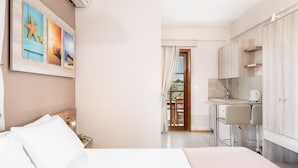 Een slaapkamer met een bed, een nachtkastje en een wandairconditioner.