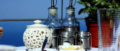 A table with various condiments and a decorative lantern, set against a blue background.