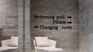 Enjoy a clean and contemporary bathroom with a sleek design, bathtub, and glass partition separating the changing area.