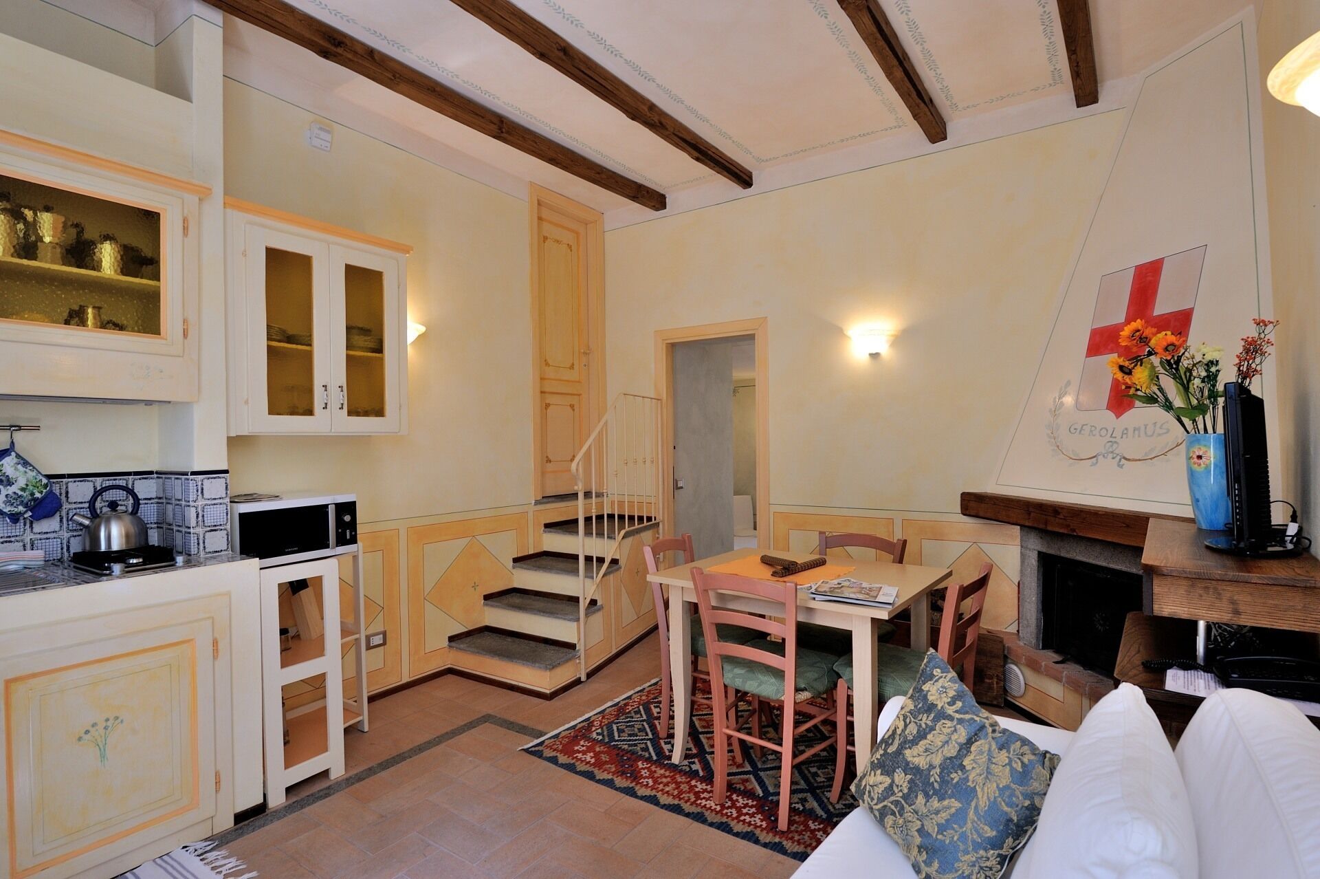 A compact living space with a kitchen, dining area, and a fireplace.