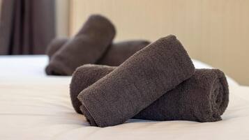 A bed with rolled towels.