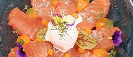 A plate of salmon with garnishes.