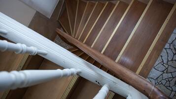 A staircase with white balusters and a wooden handrail.