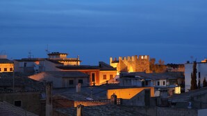 A historic town with medieval architecture, including a prominent castle-like structure. - Can Simo Turismo de Interior (Alcúdia)