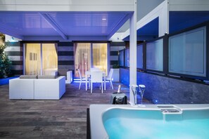 A modern indoor pool area with a seating area, a hot tub, and a dining setup. - LHP Hotel Santa Margherita Palace & SPA (Santa Margherita Ligure)