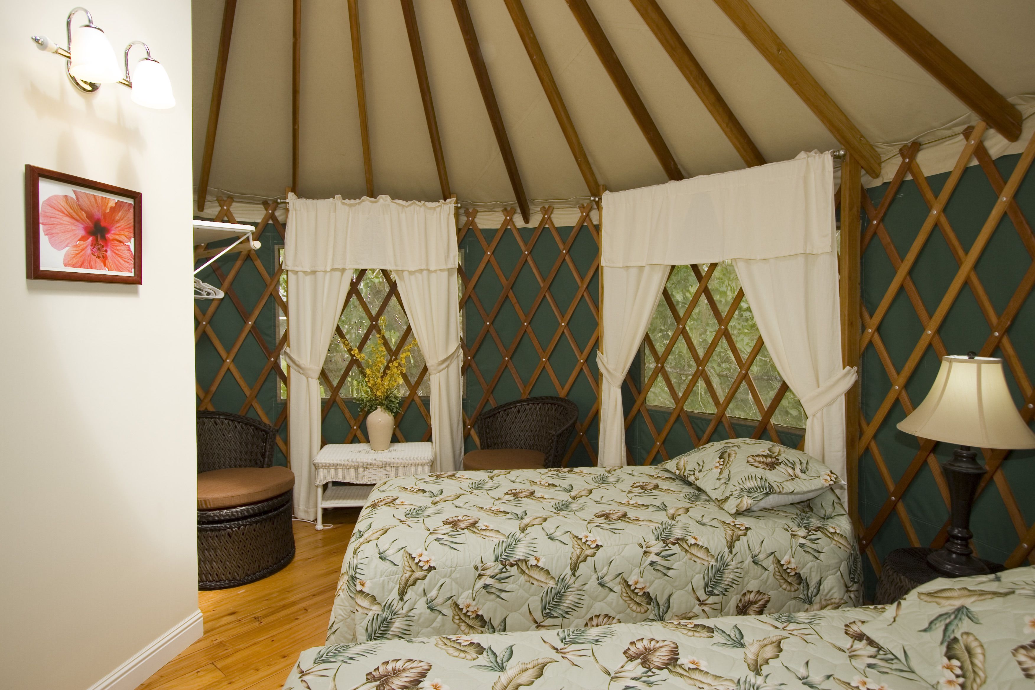A yurt with a bed, a chair, and a table.