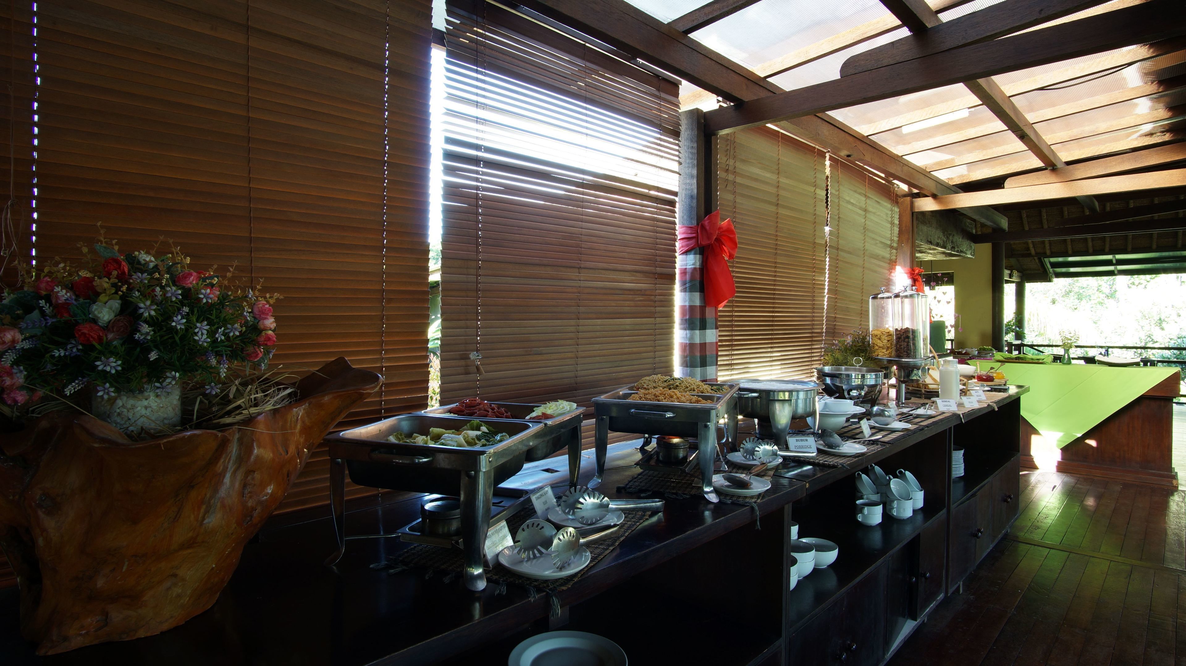 A buffet setup with various food items and utensils.