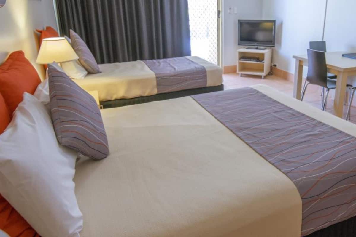 castaway studio unit  | desk, blackout curtains, iron/ironing board, cots/infant beds