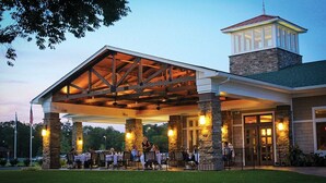 A covered outdoor seating area with stone pillars and a stone tower. - Fairfield Inn & Suites by Marriott Millville Vineland (Millville)