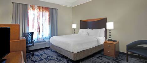 Premium bedding, desk, laptop workspace, blackout drapes