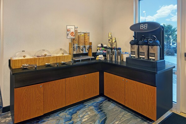 A self-service coffee station with a coffee machine, dispensers, and a variety of coffee options. - Fairfield Inn & Suites by Marriott Carlsbad (Carlsbad)