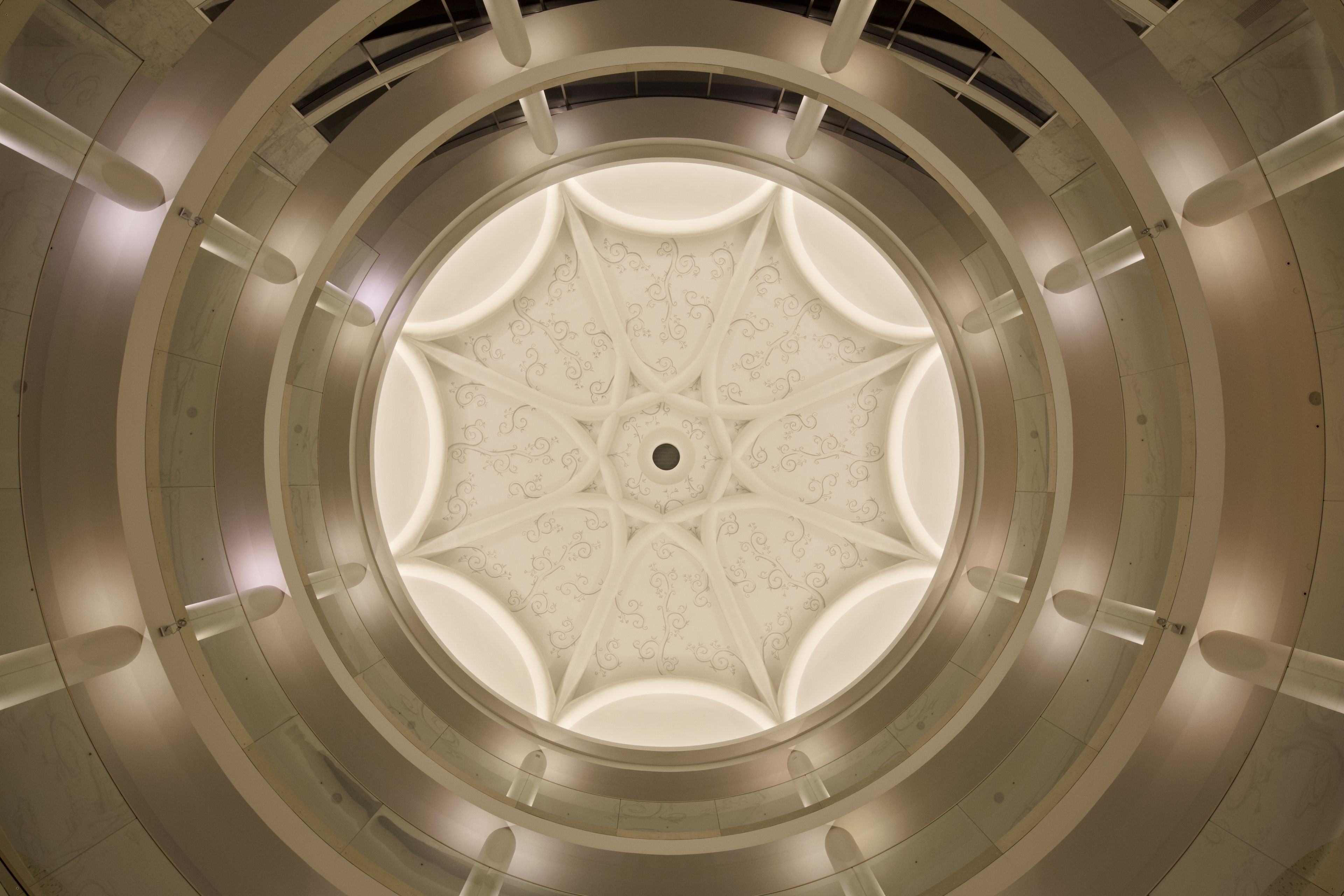 A circular architectural design with a central decorative element and radial symmetry.