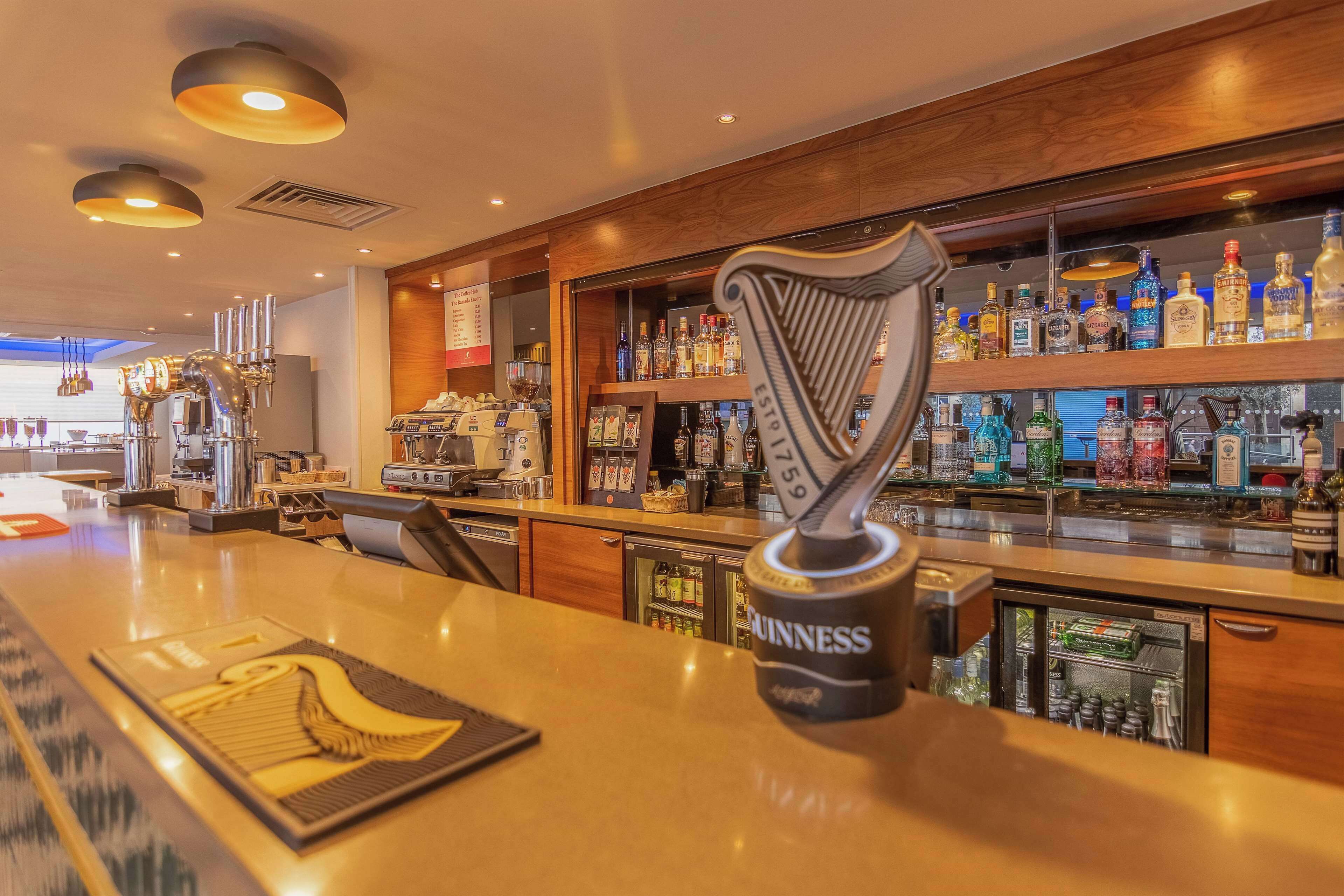 A bar area with a Guinness beer tap, various liquor bottles, and a well-lit interior.