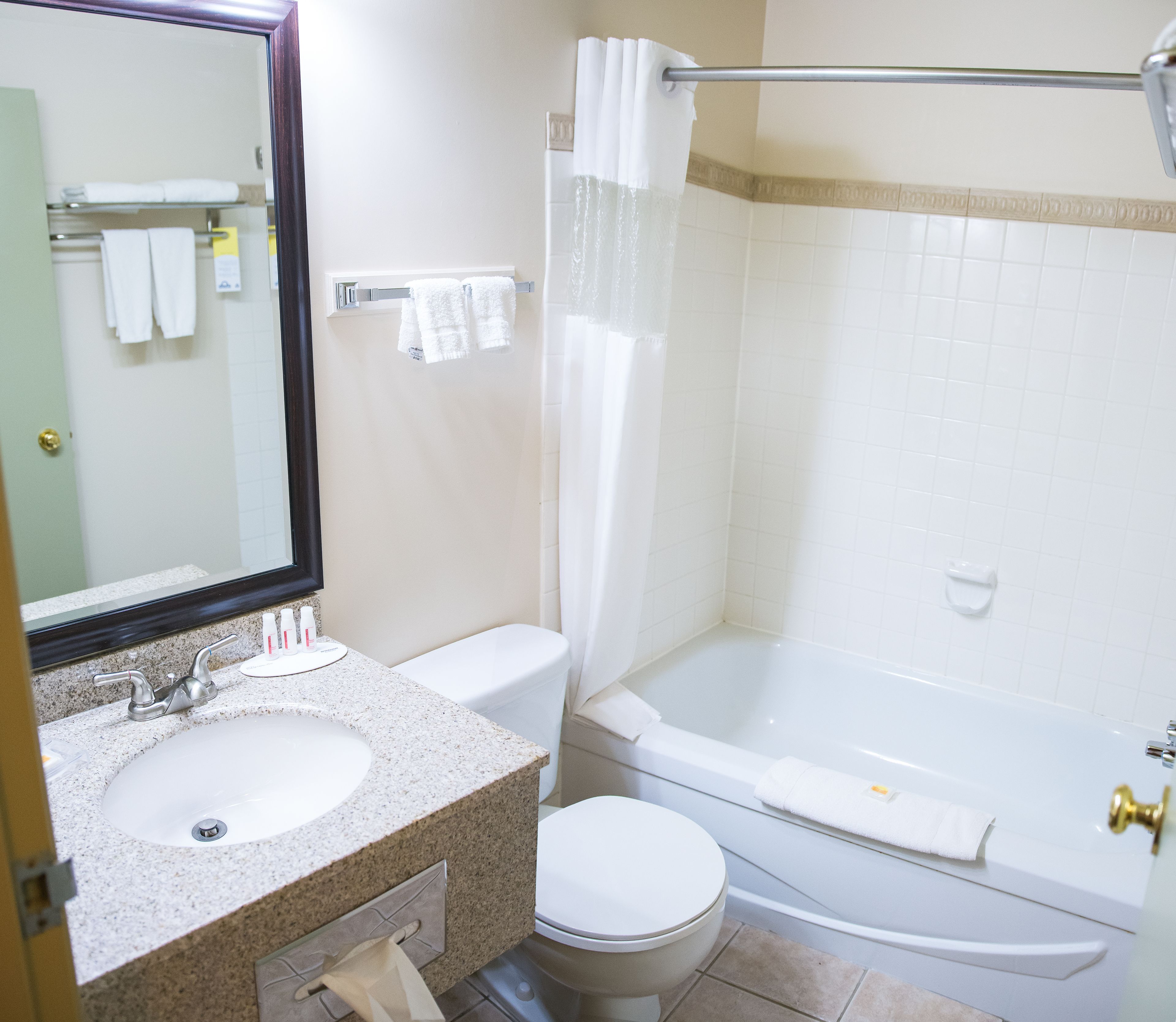 A bathroom with a sink, toilet, and bathtub.