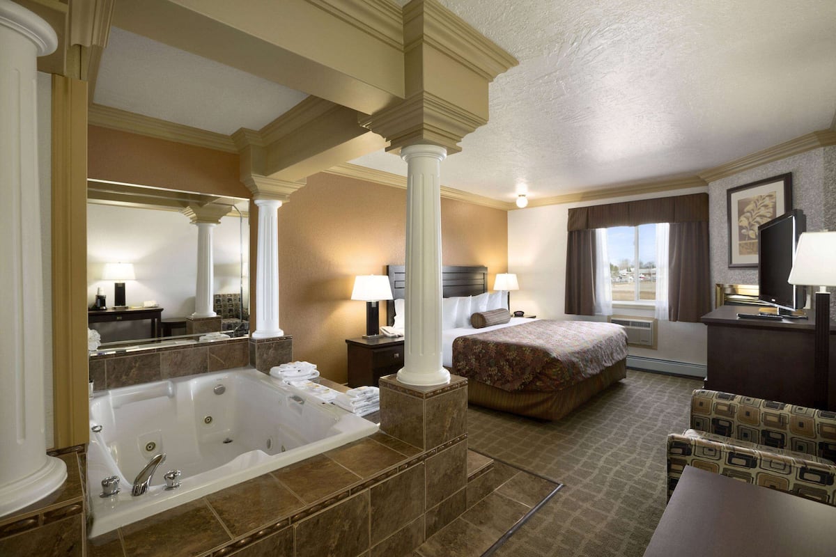 Room, 1 King Bed, Jetted Tub | 1 bedroom, hypo-allergenic bedding, desk, iron/ironing board