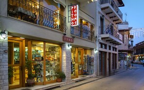 A storefront with a sign reading "PITTHOS" and a visible entrance.