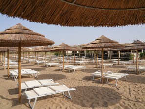 Sun-loungers, beach umbrellas, beach towels