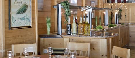 A wooden interior with a dining area, bar, and kitchen.