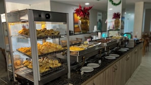 A buffet with multiple trays of baked goods and a variety of food options. - EL ARAM PONTA NEGRA (Natal)