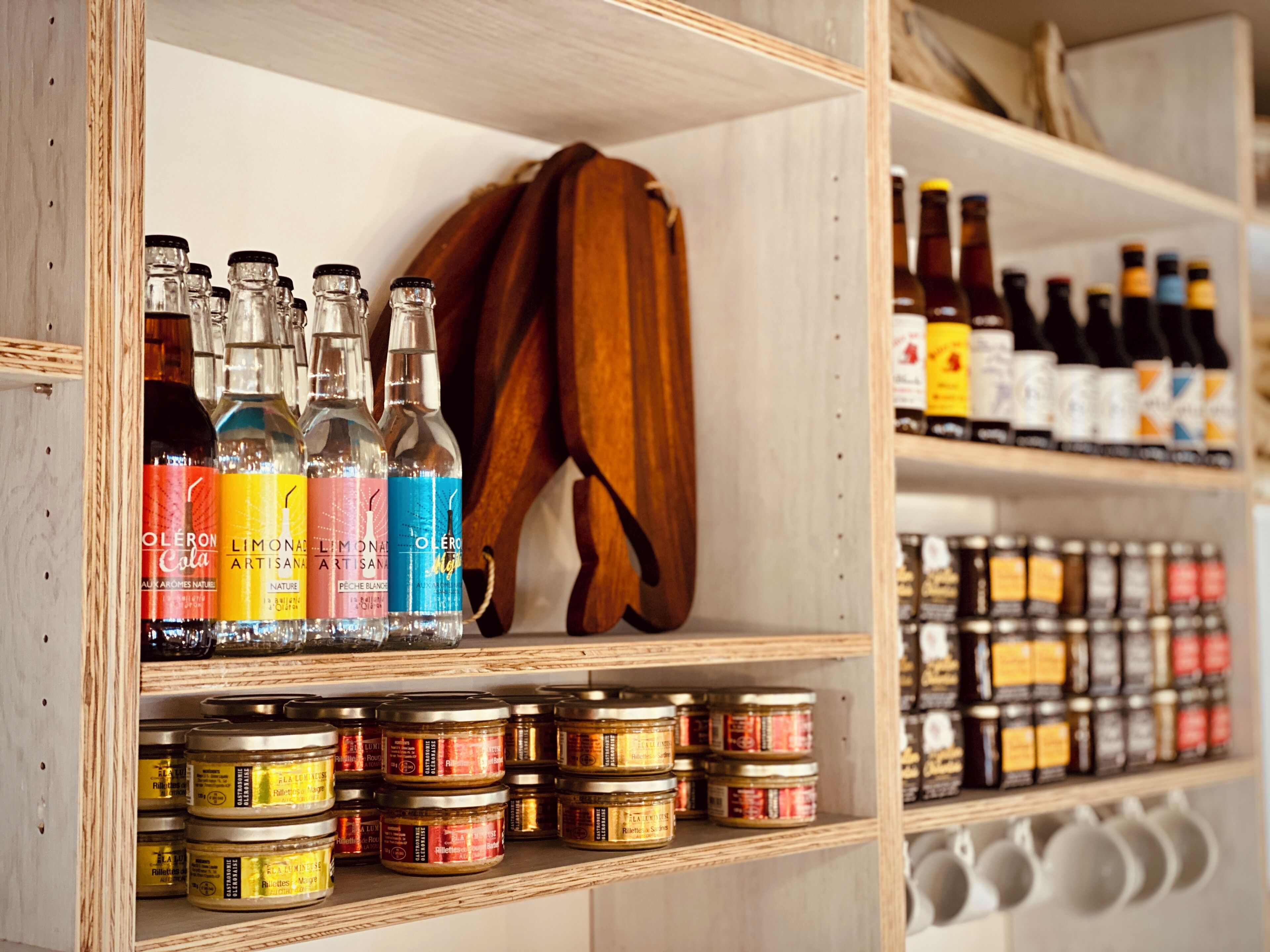 A shelf with various bottles and jars, some with labels and some without.