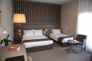 Triple Room | Minibar, in-room safe, desk, iron/ironing board