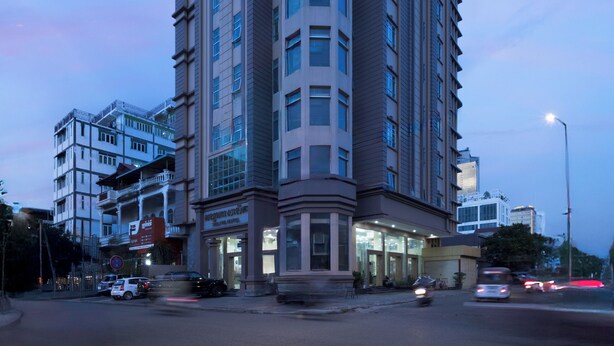 A multi-story hotel with a prominent corner entrance, large windows, and a flat roof. - Salita Hotel (Phnom Penh)