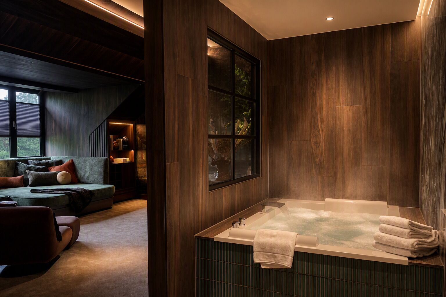 A modern bathroom with a large bathtub, wooden walls, and a window.