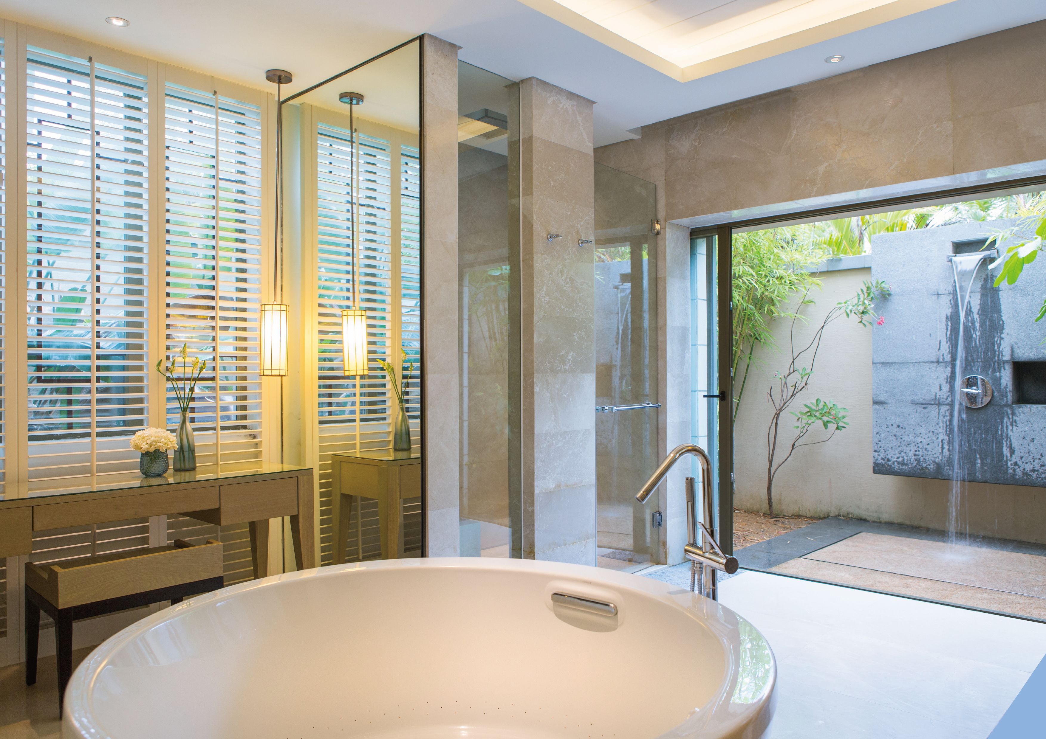 A modern bathroom with a large bathtub, a glass-enclosed shower, and a vanity with a mirror.
